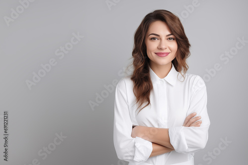 Smiling businesswoman in white shirt and gray background