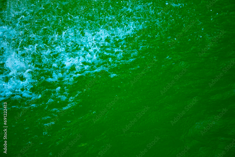 Transparent dark green clear water surface texture with ripples, splashes