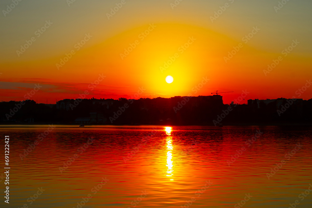 sunset at coast of the lake. Nature landscape. reflection, blue sky and yellow sunlight. landscape during sunset.