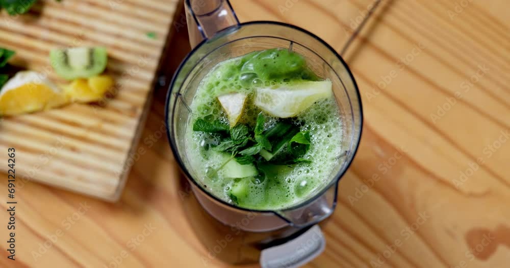 Smoothie, blender and green juice with nutritionist, gut health and weight loss drink from above. Kitchen, vegetables and wellness with diet, spinach and protein shake with kale and kiwi fruit Smoothie, blender and green juice with nutritionist, gut health and weight loss drink from above. Kitchen, vegetables and wellness with diet, spinach and protein shake with kale and kiwi fruit