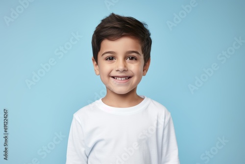 smiling little boy in a white t-shirt on a blue background