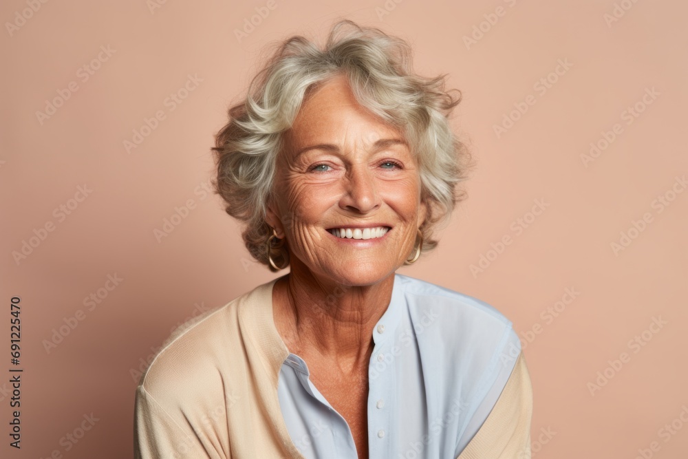 Portrait of a smiling senior woman. Isolated on a pink background. Portrait of a smiling senior woman. Isolated on a pink background.