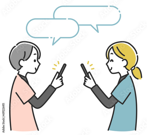 スマホで連絡を取り合う女性医療スタッフ