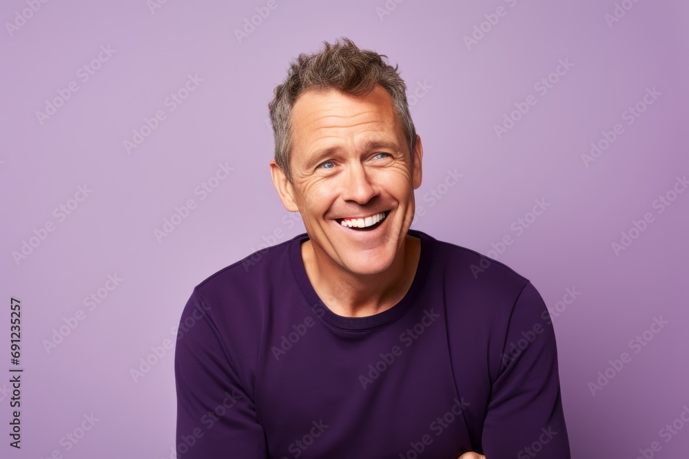 Portrait of a happy middle aged man, isolated over purple background. Portrait of a happy middle aged man, isolated over purple background.