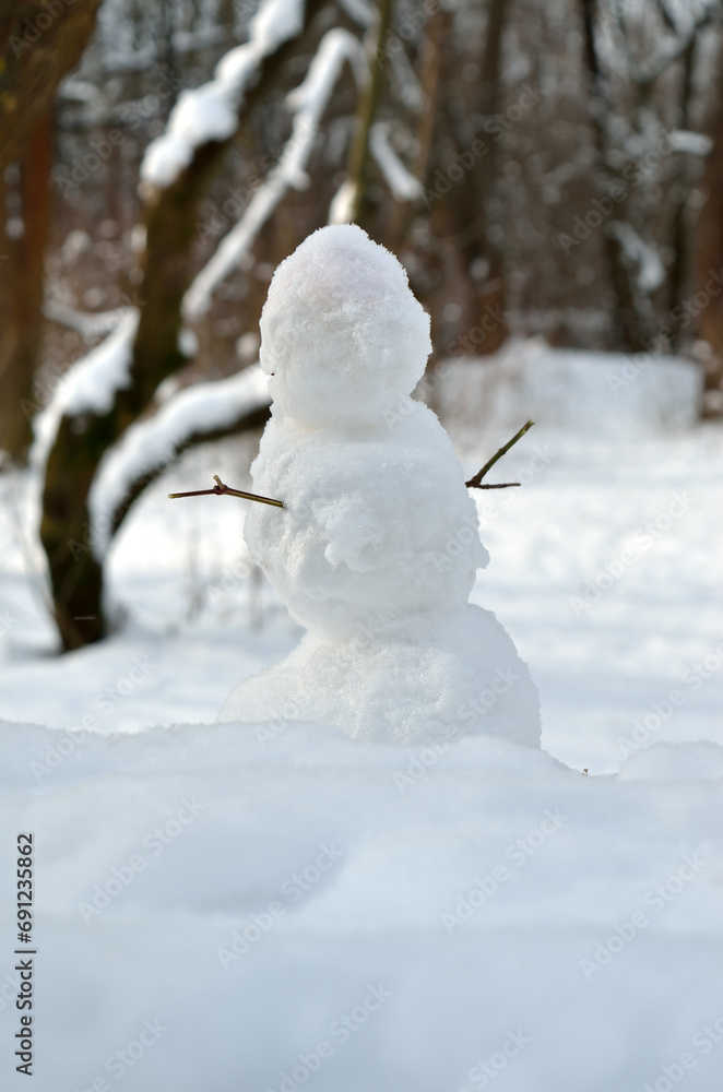 Figure of a snowman against a background of white snow Figure of a snowman against a background of white snow