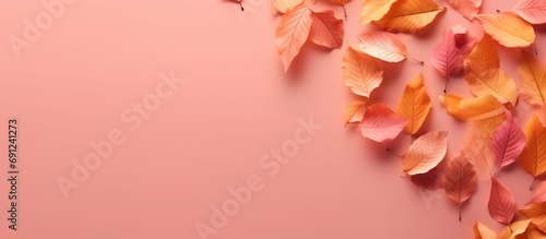 Copy space, illustration of fallen orange leaves faded pink background