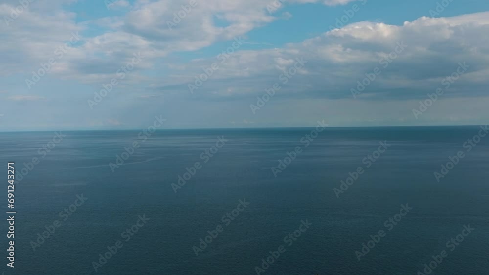 Flying over the blue sea with blue sky and clouds. Camiguin, Philippines. Flying over the blue sea with blue sky and clouds. Camiguin, Philippines.