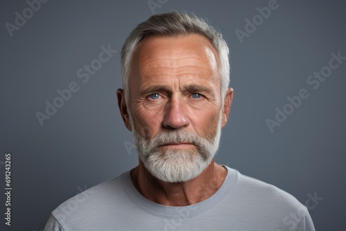 Portrait of a senior man with gray hair and beard. Studio shot.