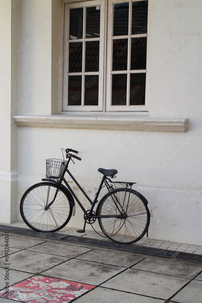 old bicycle in front of a brick wall