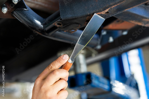 Man Repairing Rust Damage in Vehicle's Interior