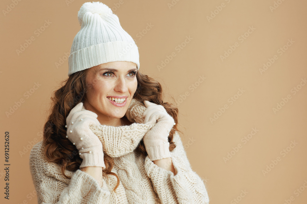 smiling elegant woman against beige background smiling elegant woman against beige background