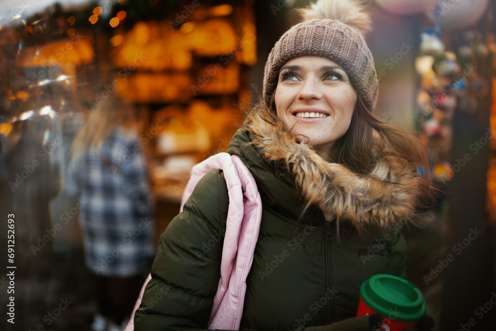 smiling modern woman at winter fair in city smiling modern woman at winter fair in city
