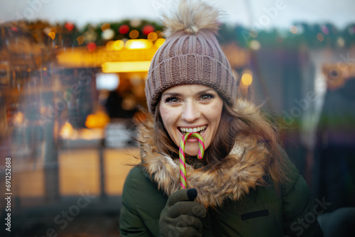 smiling modern woman at winter fair in city