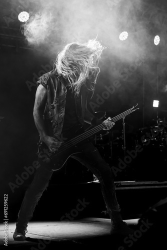 Guitarist on stage playing metal rock before the crowd, guitar concept photo