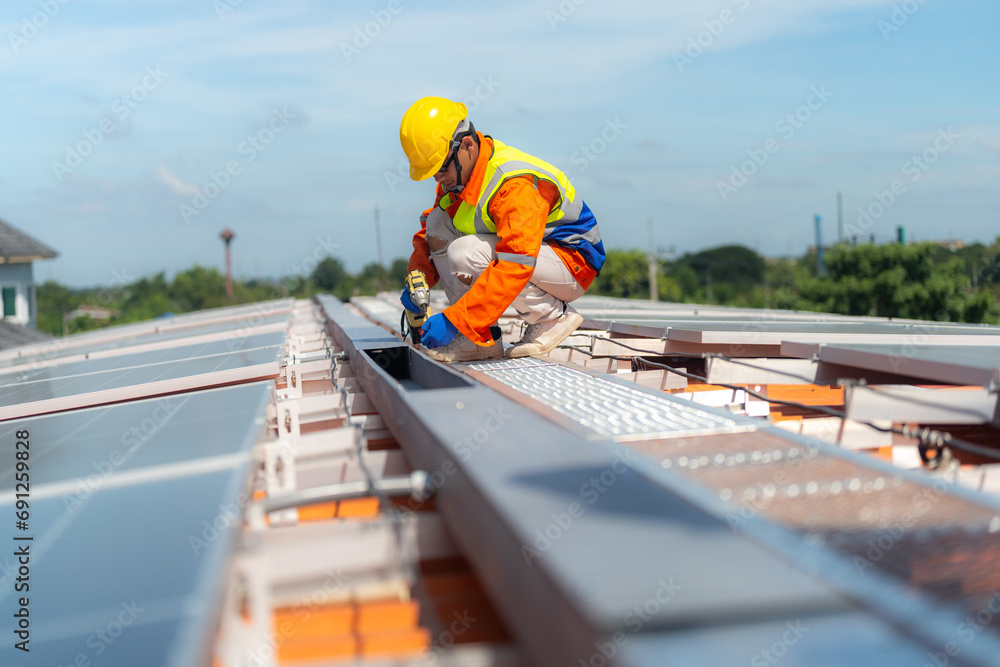 Worker Technicians are working to construct solar panels system on roof. Installing solar photovoltaic panel system. Alternative energy ecological concept. Renewable clean energy technology concept. Worker Technicians are working to construct solar panels system on roof. Installing solar photovoltaic panel system. Alternative energy ecological concept. Renewable clean energy technology concept.