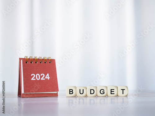 2024 desk calendar and Wooden blocks with the word BUDGET. The concept about budget planning and allocation in year 2024 photo