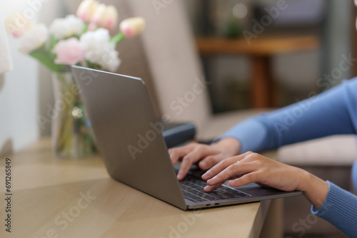 Close up of hands woman specialist working on laptop computer at Home