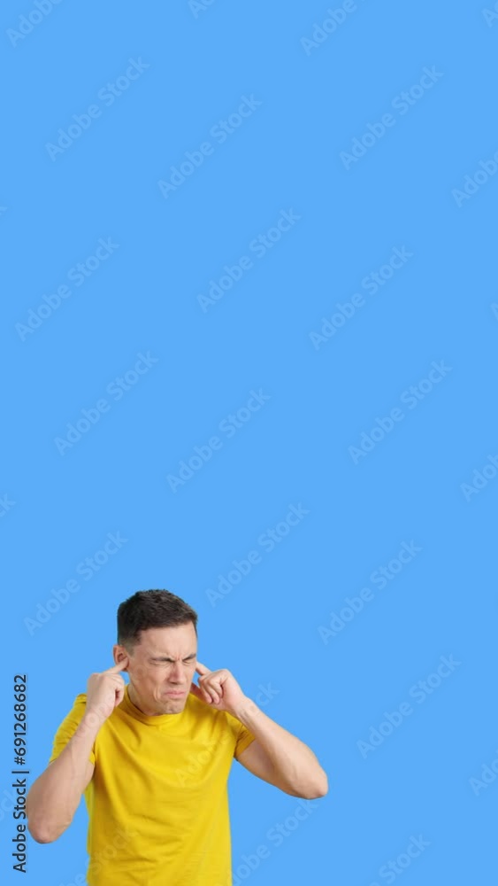 Man covers his ears with his hands due to noise Man covers his ears with his hands due to noise