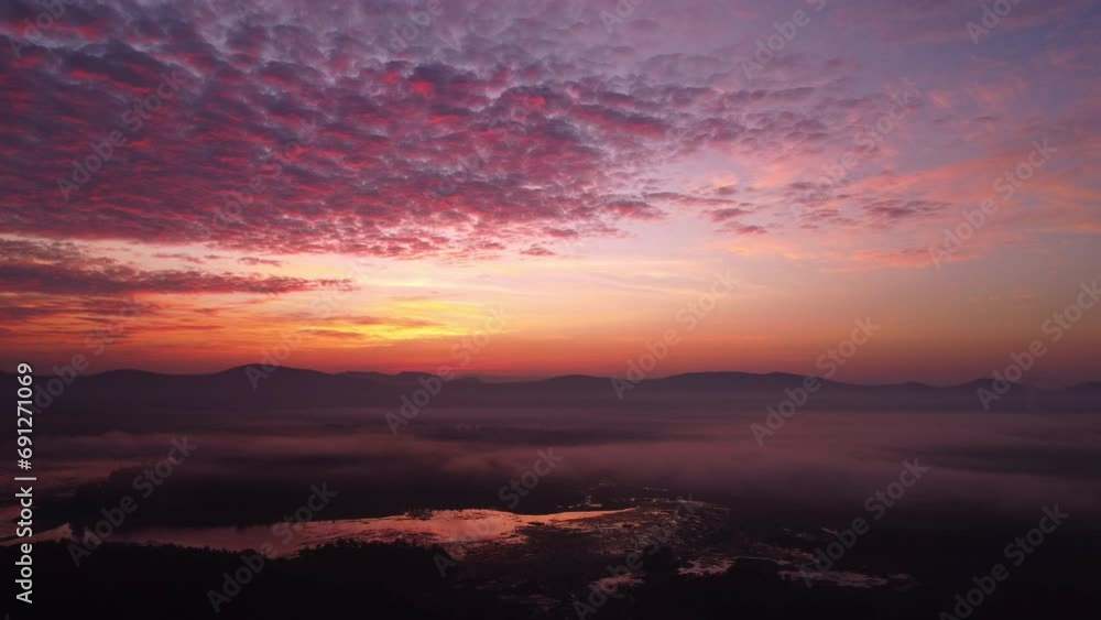 Sunrise sky, beautiful nature morning with orange, yellow sunshine and fluffy clouds. Beautiful colorful dramatic sky with clouds at sunset or sunrise by the lake. Sunrise sky, beautiful nature morning with orange, yellow sunshine and fluffy clouds. Beautiful colorful dramatic sky with clouds at sunset or sunrise by the lake.