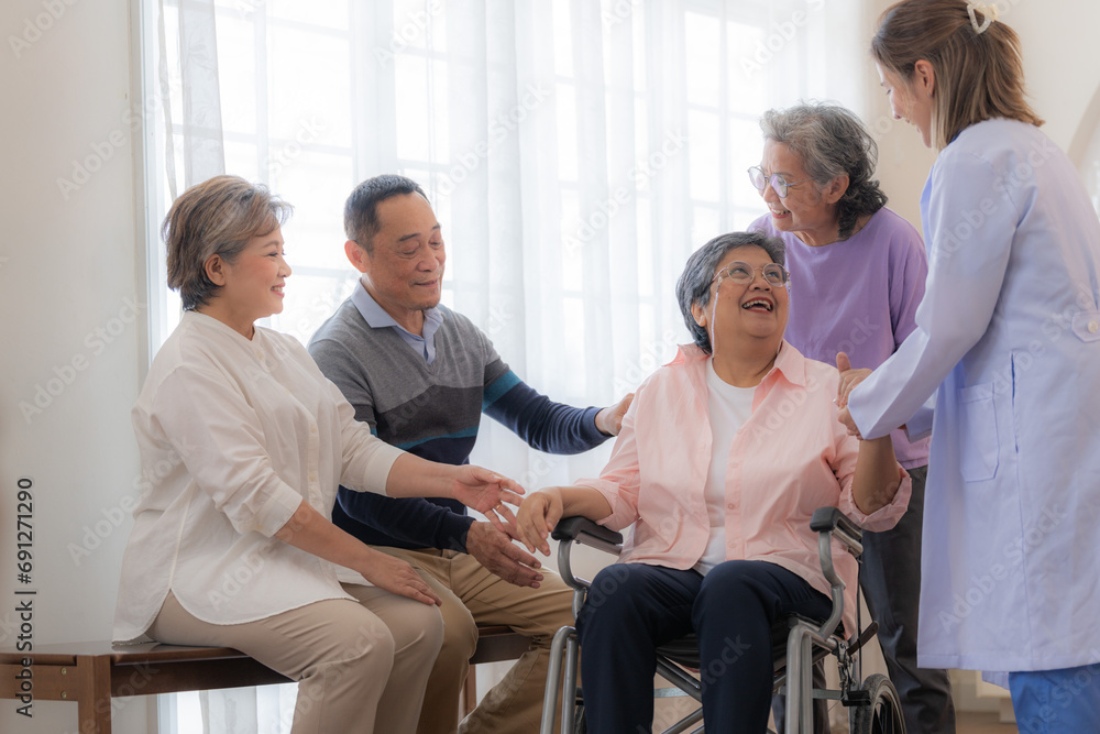 Asian young nurse support couple senior older woman in a wheelchair. elderly mature and a group of senior friends living in the hospital. socializing of retired people. Asian young nurse support couple senior older woman in a wheelchair. elderly mature and a group of senior friends living in the hospital. socializing of retired people.