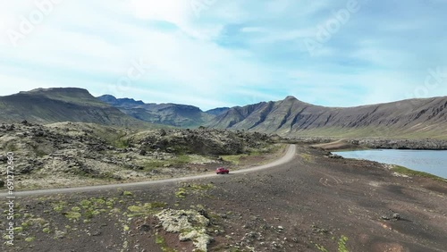 Car Driving Across The Road Through Huge Berserkjahraun Lava Field, Snaefellsnes Peninsula, West Island. Aerial Shot photo