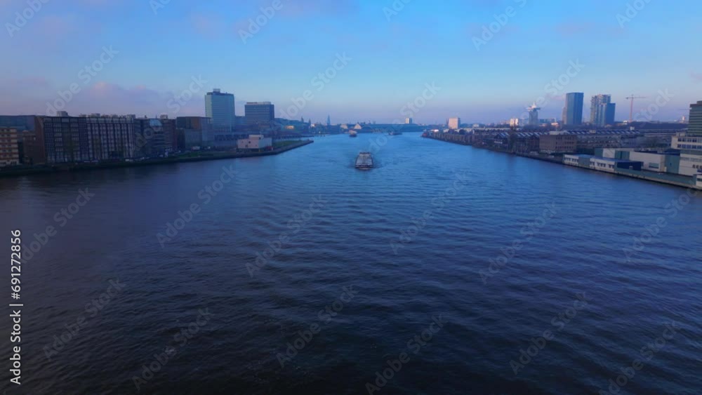 Tanker Ship coming through the North Sea Canal with Amsterdam City in Background Tanker Ship coming through the North Sea Canal with Amsterdam City in Background