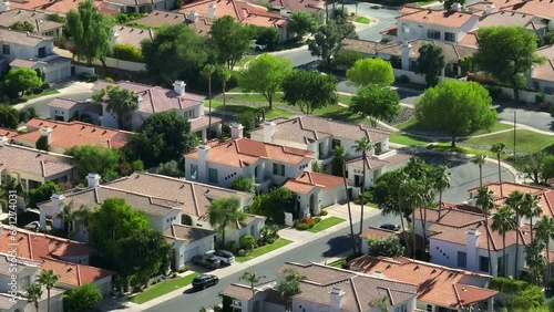 High end Southwest USA neighborhood with terracotta roof houses and palm trees. Retirement community on country club golf course.
