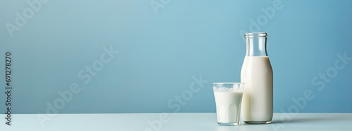Bottle and glass of milk on isolated background photo