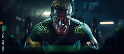 Athlete in dimly-lit gym with neon glow, undergoing training.