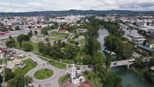 Aerial View Of Banja Luka City Flying Over Orthodox church Beside River Vrbas. Push Forward Shot photo