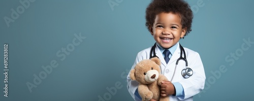 A african american child in a doctor s attire stands against a soft and clean backdrop  holding a toy stethoscope with a smile.