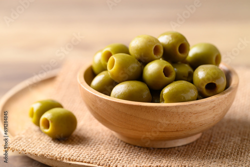 Photos Pickled olives, Pitted green olives in wooden bowl