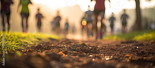 Blur of urban park marathon runners walking, focusing on fitness, healthy lifestyle, and road beneath feet.