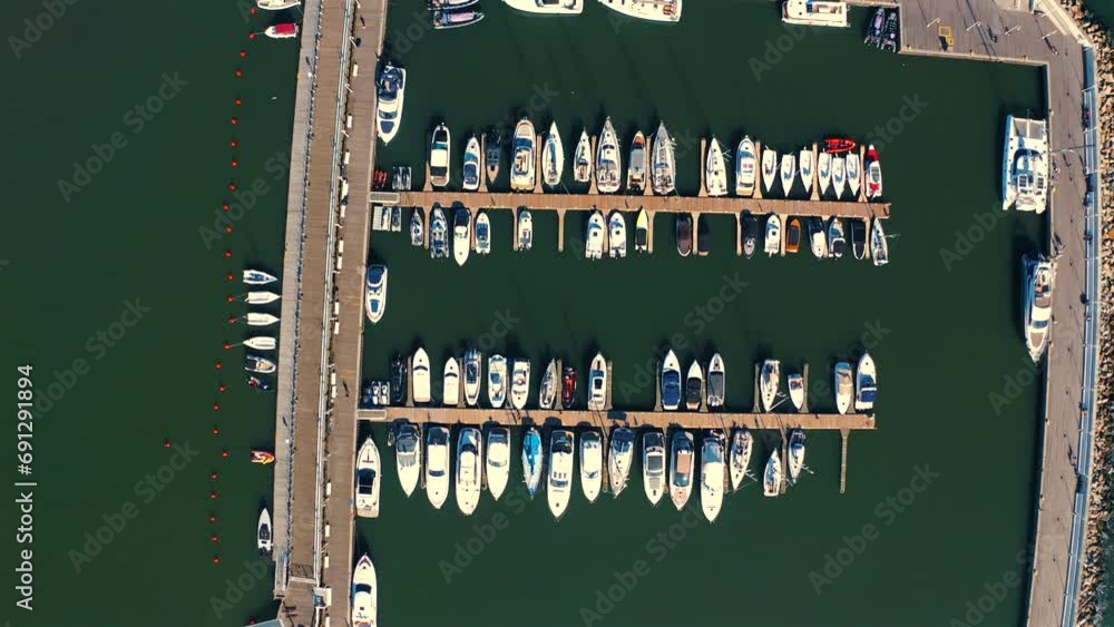Top view of the marina in Sopoto with moored yachts, ships and motorboats at the sunset Top view of the marina in Sopoto with moored yachts, ships and motorboats at the sunset