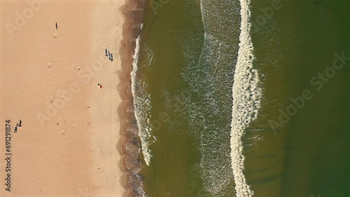 Drone top view of sea waves and beach at sunny day photo