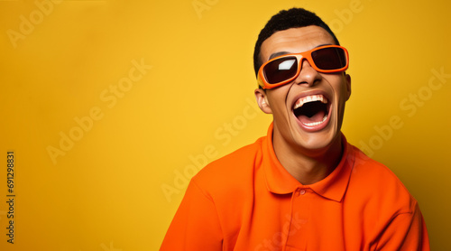 The bright, innocent smile of a disabled boy wearing glasses in a yellow-orange tone © Duka Mer