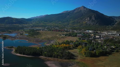 Early fall colors Aspen trees downtown Frisco Main Street  Lake Dillon islands Colorado aerial cinematic drone morning view Frisco Breckenridge Silverthorne Ten Mile Range pan up reveal forward motion photo