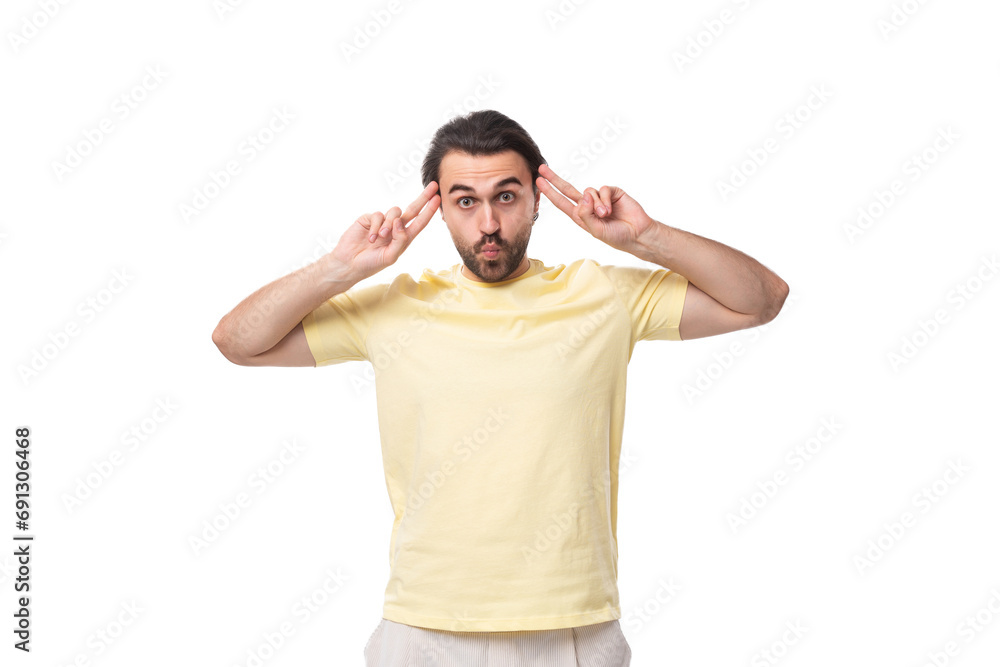 a young smart man with a black beard and mustache dressed in a T-shirt is thinking about the development of a business strategy a young smart man with a black beard and mustache dressed in a T-shirt is thinking about the development of a business strategy