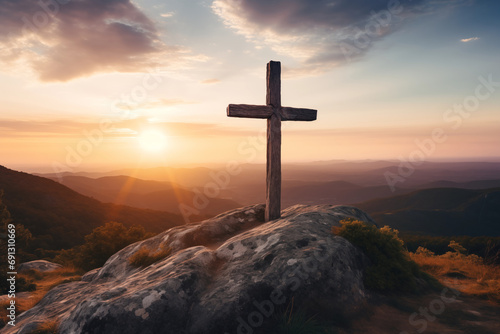 Christian cross on the mountain at sunset. A symbol of the resurrection of Jesus Christ.