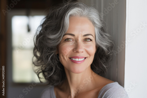 a woman with grey hair and a smile