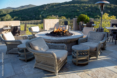 Chairs and side tables around fire pit for gathering.