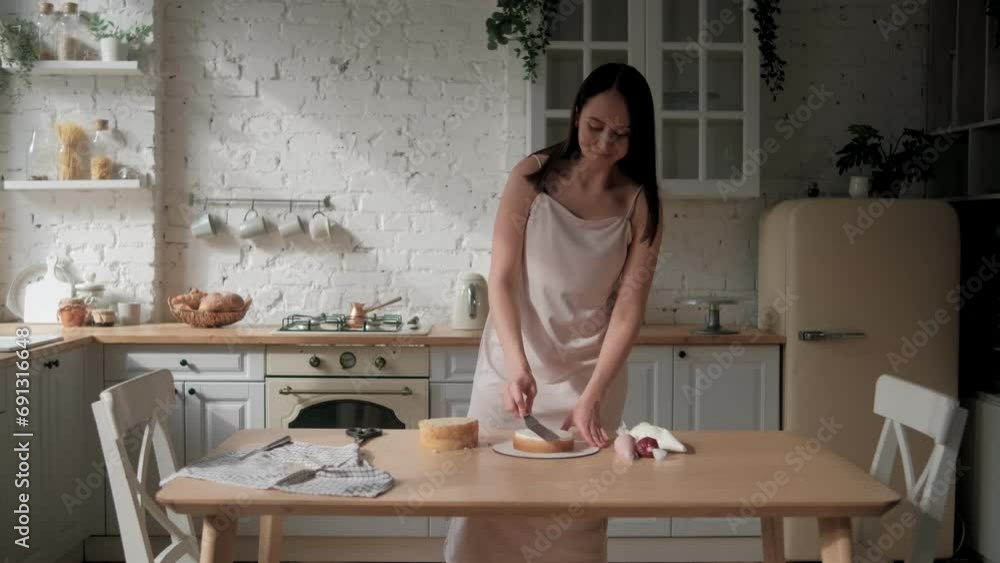 Woman is cooking homemade cake. Pastry chef collects cake from biscuit layers, cake preparation. cooking, baking and cooking, home cooking Woman is cooking homemade cake. Pastry chef collects cake from biscuit layers, cake preparation. cooking, baking and cooking, home cooking