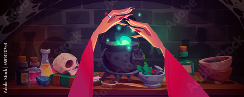 Witch hands conjuring over cauldron with brewing green glowing potion with bubbles. Cartoon game vector illustration of table with magical wizard ingredients and accessories for poison-making.