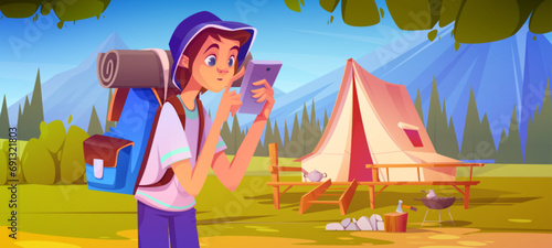 Teenage boy with hiking backpack and equipment is looking at his phone as he stands in forest near tent on wooden patio and campfire. Cartoon summer landscape with camping tourist near mountains.