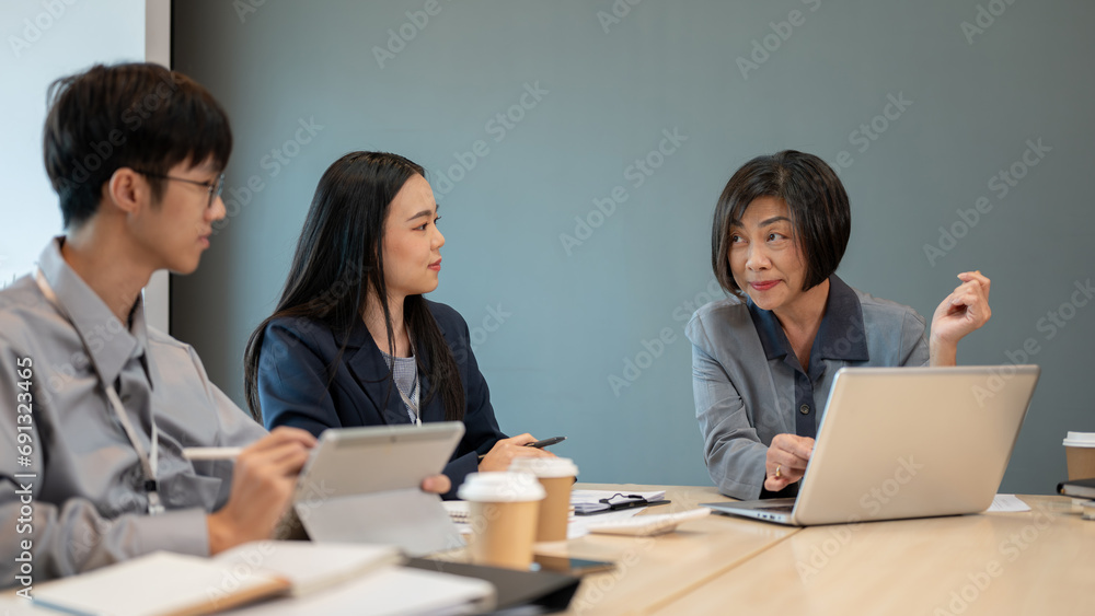 Group of diverse professional Asian businesspeople are in the meeting, consulting about new project. Group of diverse professional Asian businesspeople are in the meeting, consulting about new project.