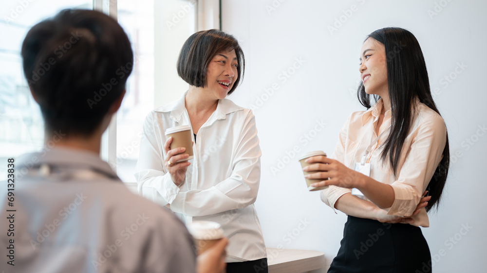Group of friendly and happy diverse Asian businesspeople are enjoying chatting during a coffee break Group of friendly and happy diverse Asian businesspeople are enjoying chatting during a coffee break