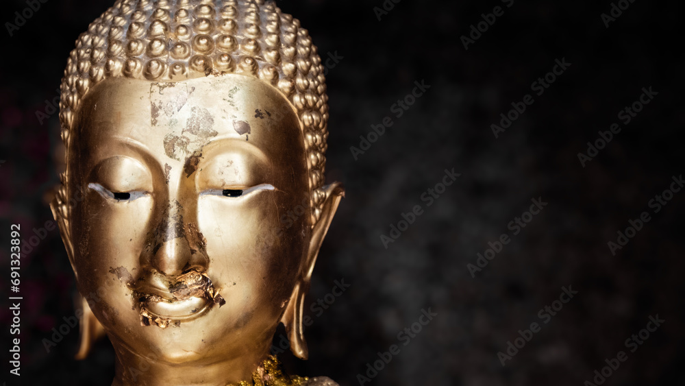 Buddha's face on blur background, Believe in Buddhism, Buddha statue used as amulets of Buddhism religion