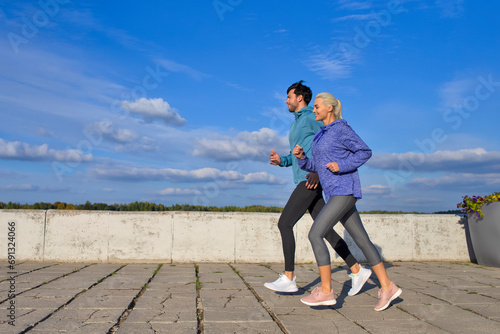 Smiling Positive Runners Together During Running Training Fitness Exercise At Nature Outside as Runners During Training Process. photo