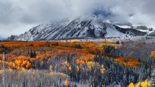 Stunning Kebler Pass Crested Butte Colorado stunning fall winter first snow seasons collide aerial cinematic drone yellow aspen tree forest Rocky Mountains fog clouds lifting upward jib motion photo