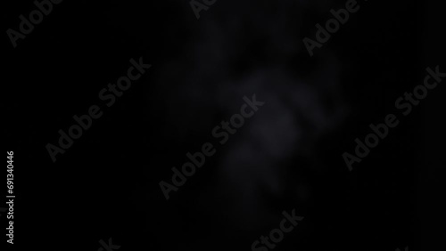 Dynamic movement of white steam rising quickly against a deep black background. 4k footage. photo